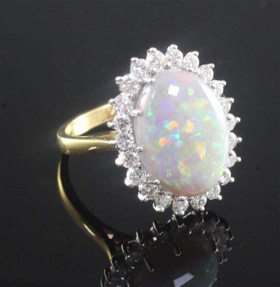 An 18ct gold, white opal and diamond oval cluster ring, size N.